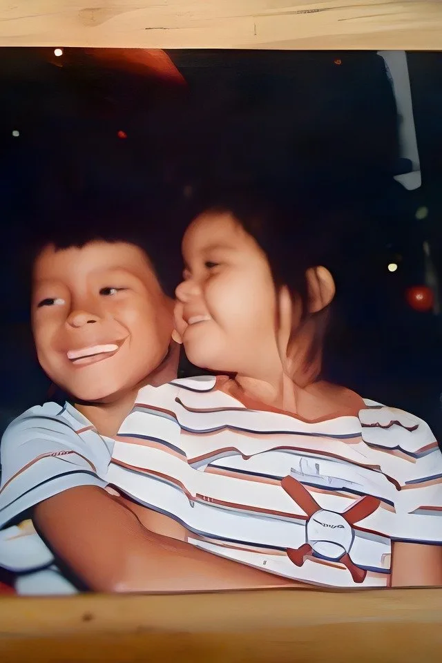 cousins laughing behind wood slats