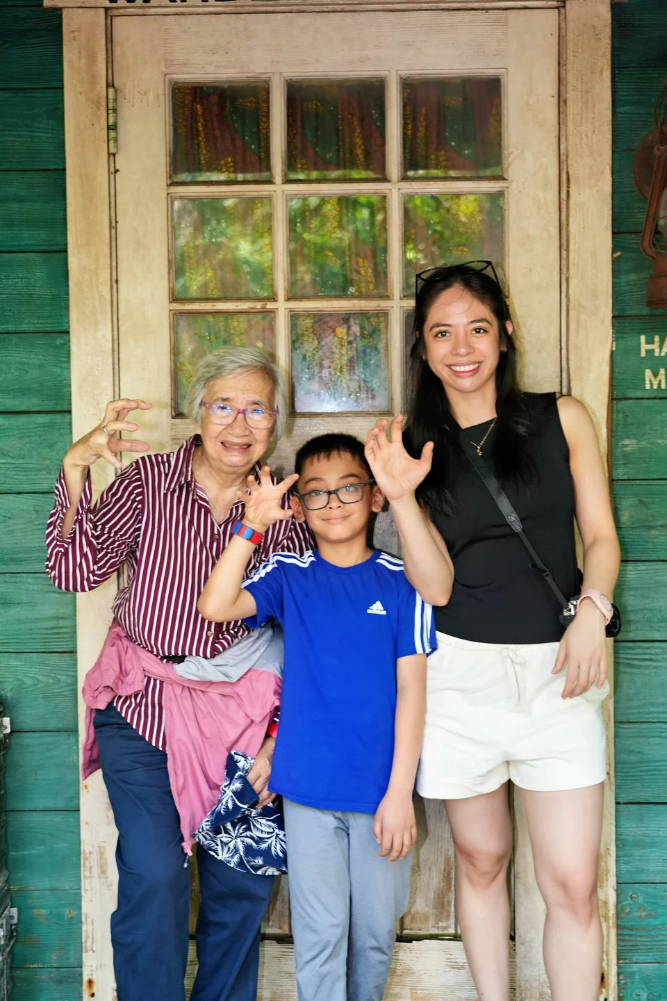 three generations waving doorway